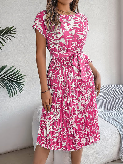 Elegante jurk met bloemenprint strikdetail en geplooide rok