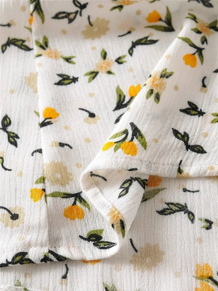 Zomerse midi jurk met V-hals en korte ballonmouwen met subtiele bloemenprint