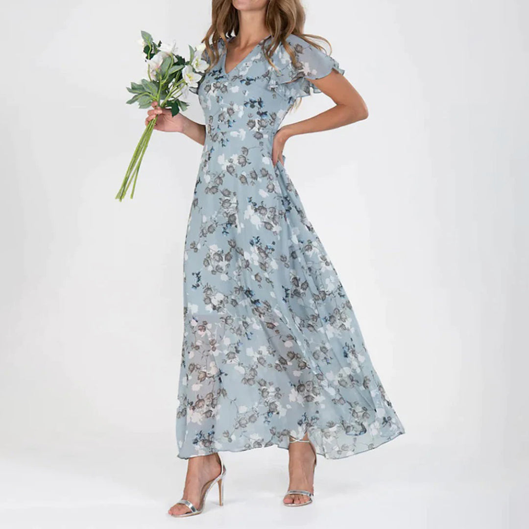 Lange damesjurk met bloemenprint en korte vlindermouwen voor een romantische zomerlook