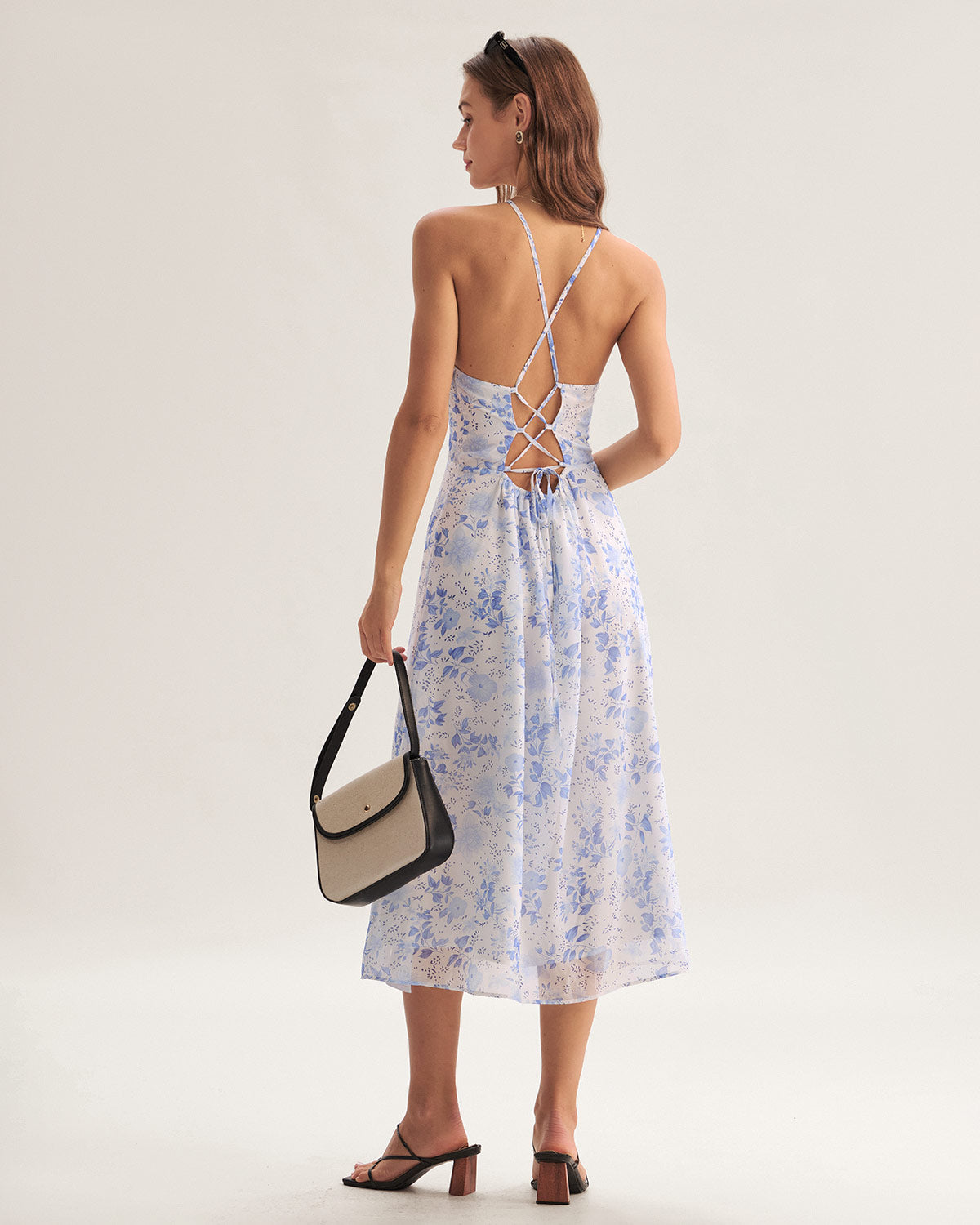 Elegante halterjurk met bloemenmotief en middellange lengte