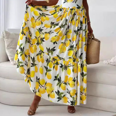 Maxi zomerjurk met fruitprint en elegante uitsnijding