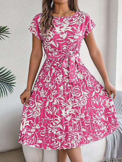 Elegante jurk met bloemenprint strikdetail en geplooide rok