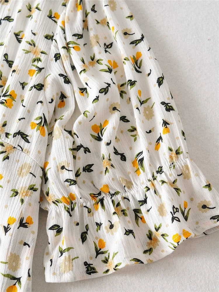 Zomerse midi jurk met V-hals en korte ballonmouwen met subtiele bloemenprint