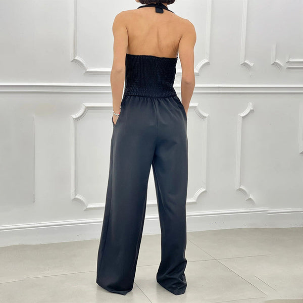 Mouwloze dames jumpsuit met halternek wijde pijpen en knopen aan de voorkant
