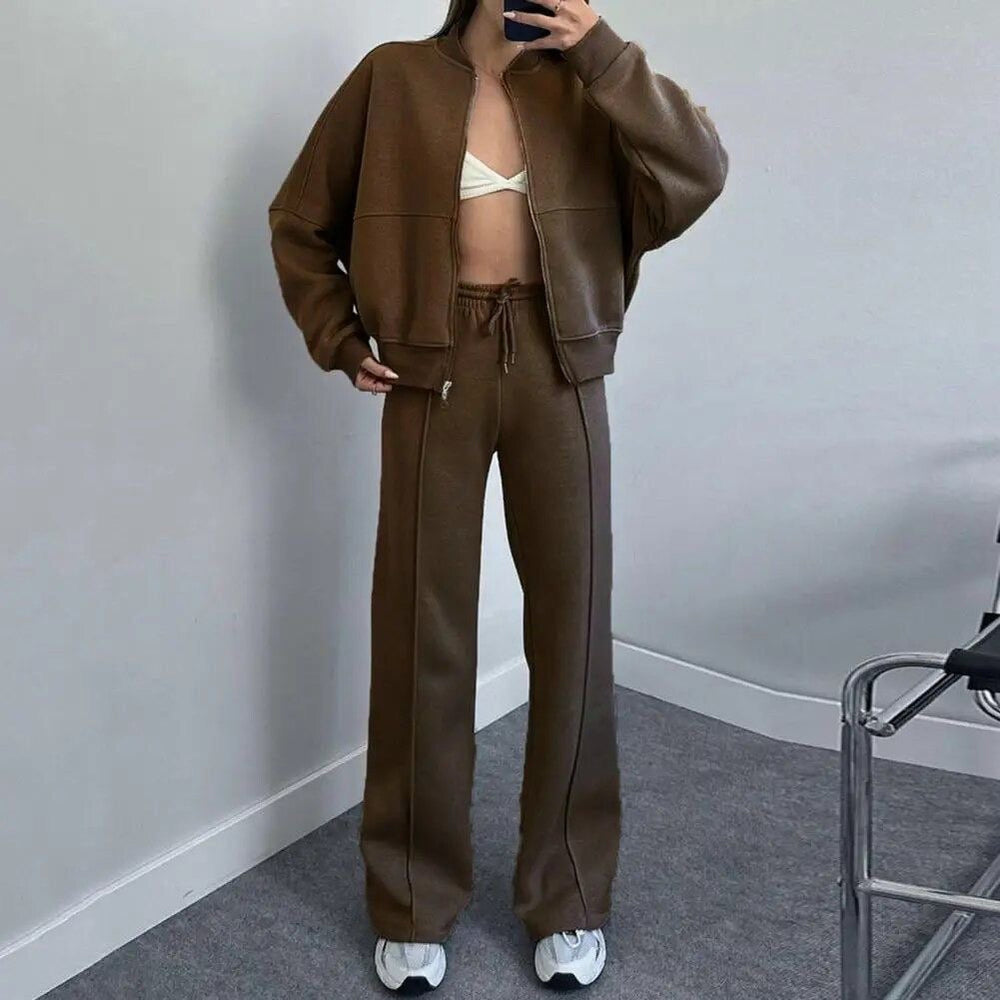 Nonchalant dames trainingspak met ritssluiting en high-waist uitlopende broek