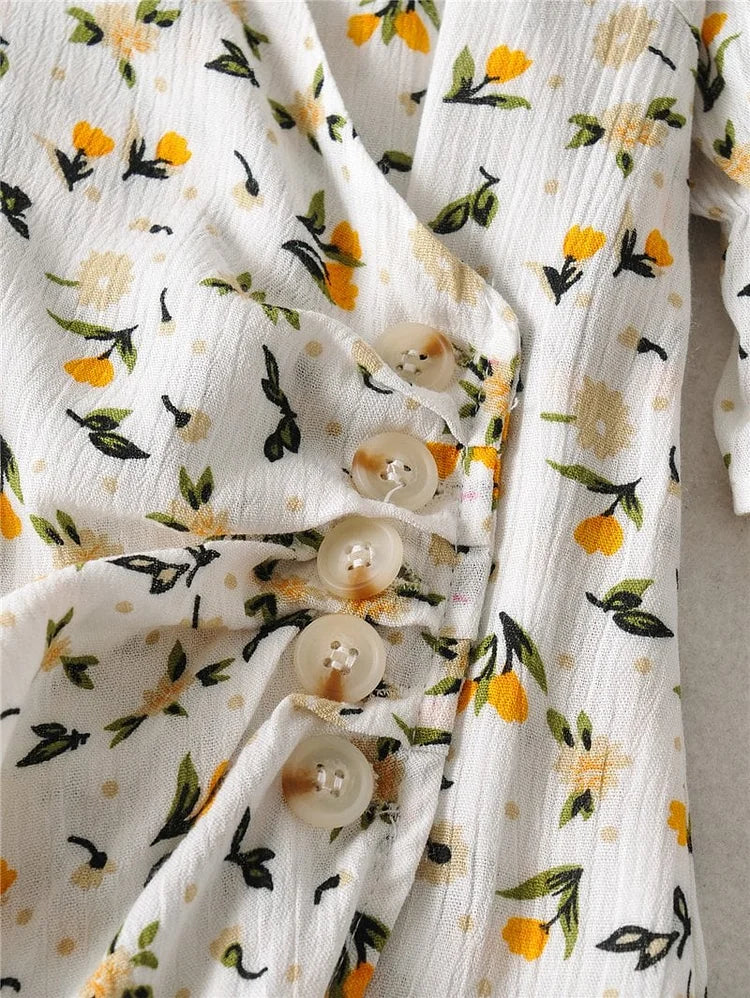 Zomerse midi jurk met V-hals en korte ballonmouwen met subtiele bloemenprint