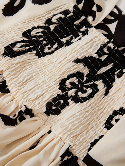 Lange mouwloze jurk met retro print en elegante uitstraling
